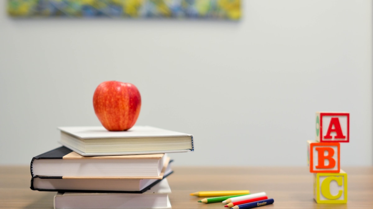 Colorful educational supplies including pencils, notebooks, and art materials on a desk